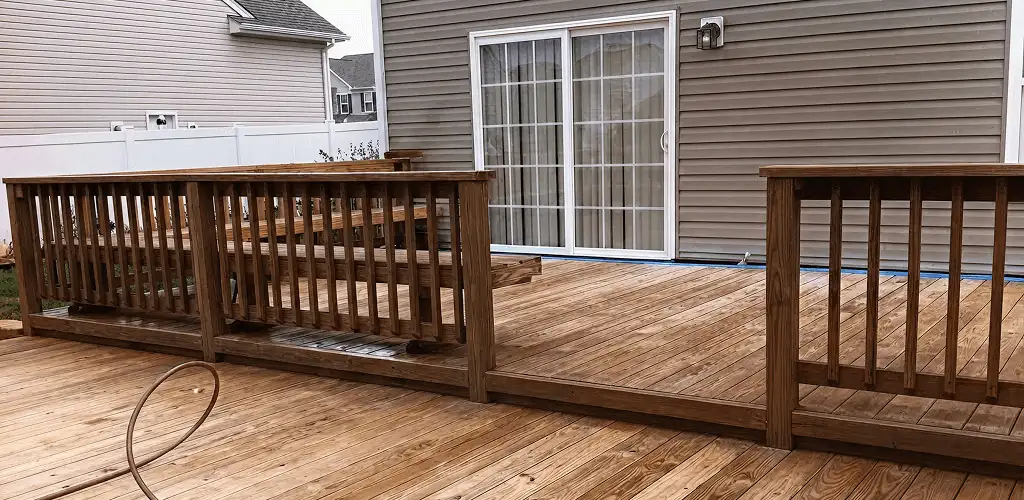 Deck sealing service protecting a backyard wood deck and railings in Madison, WI