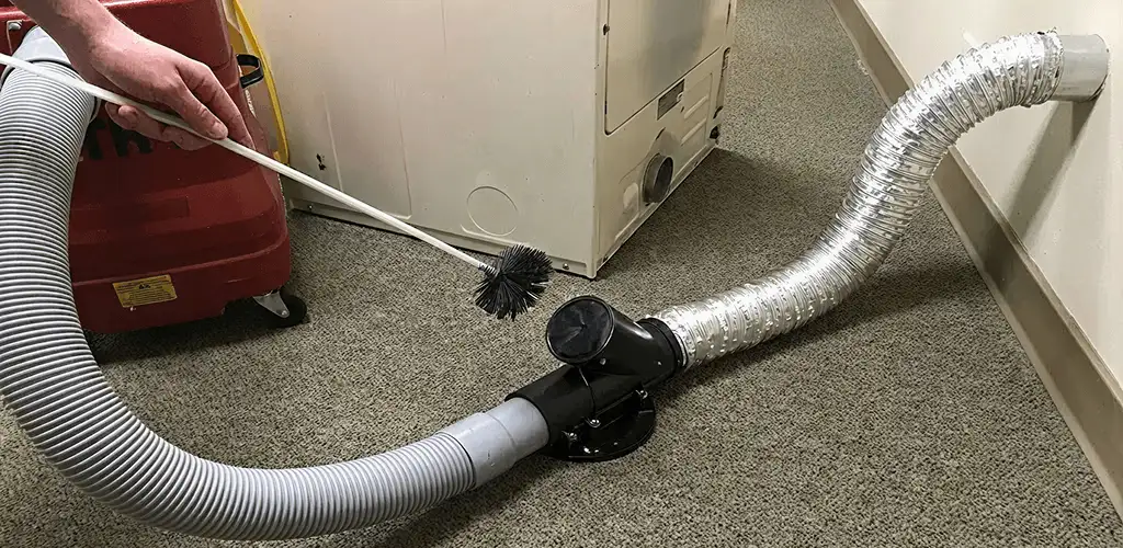 Dryer vent cleaning service removing lint from a dryer duct connection in Madison, WI