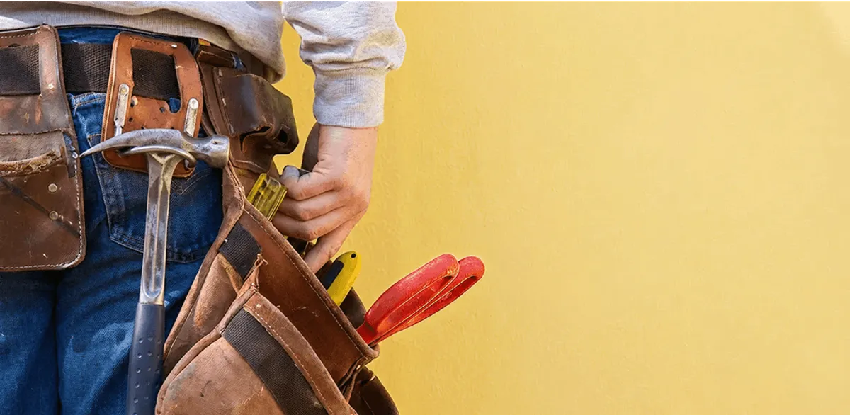 Handyman with tool belt ready for home repairs and maintenance in Madison, WI