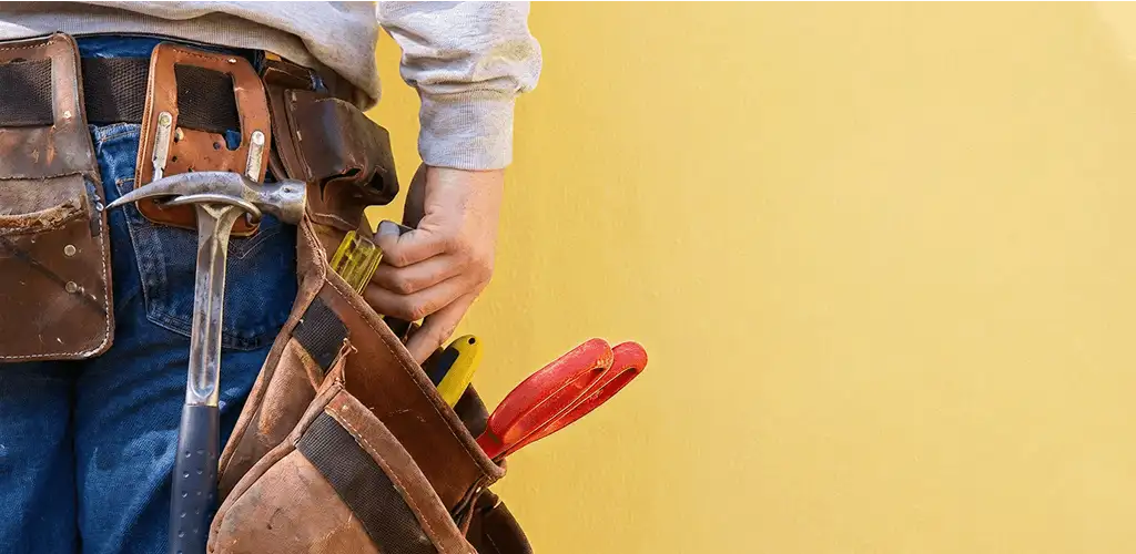 Handyman with tool belt ready for home repairs and maintenance in Madison, WI