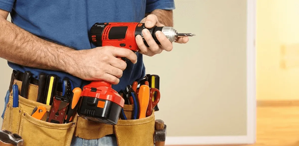 Handyman holding a power drill for home repairs and installations in Madison, WI