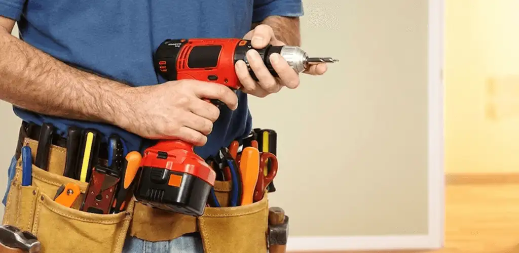 Handyman holding a power drill for home repairs and installations in Madison, WI