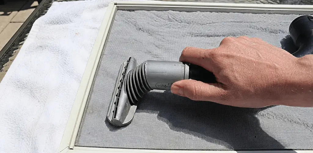 Window screen repair cleaning and fixing a damaged screen mesh in Madison, WI